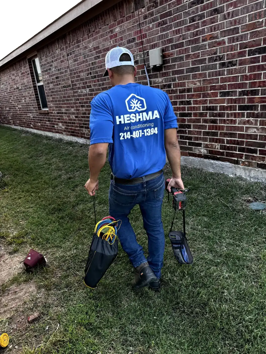 Heshma Air Conditioning technician preparing tools for a fast residential service call