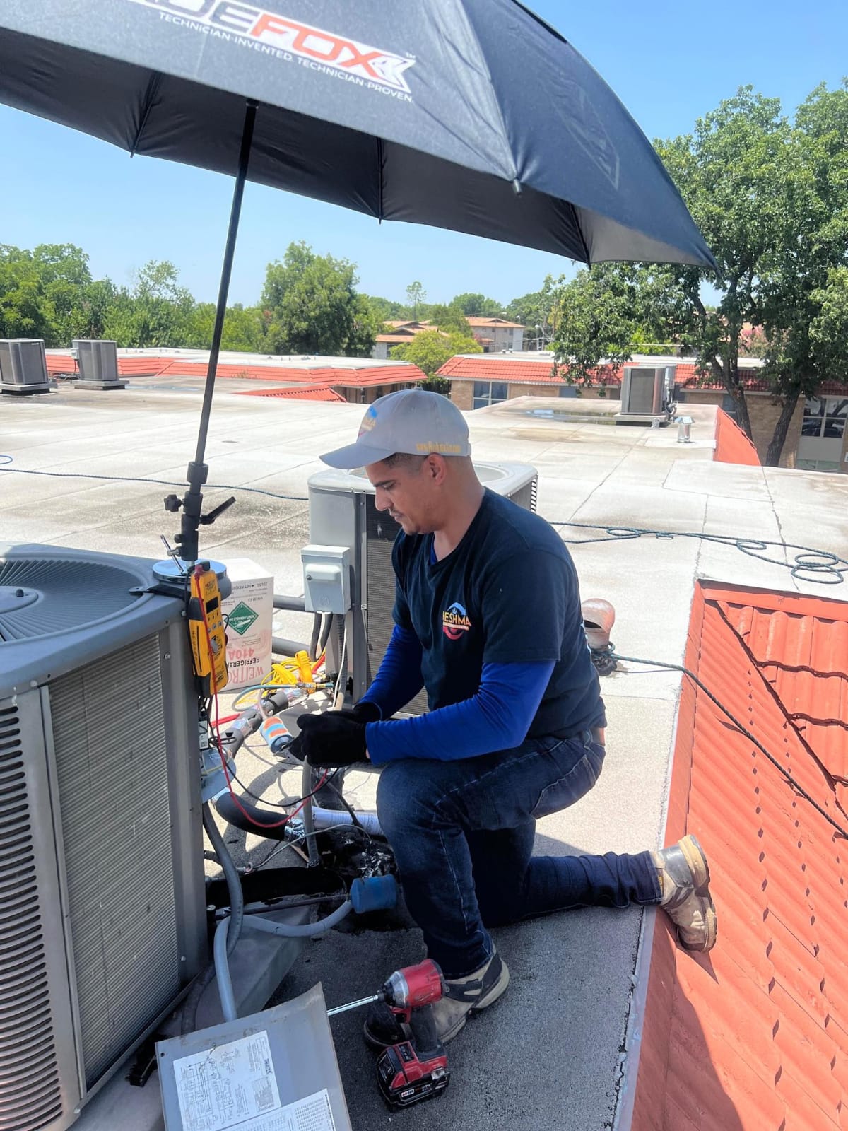 Heshma Air Conditioning technician performing detailed HVAC maintenance work
