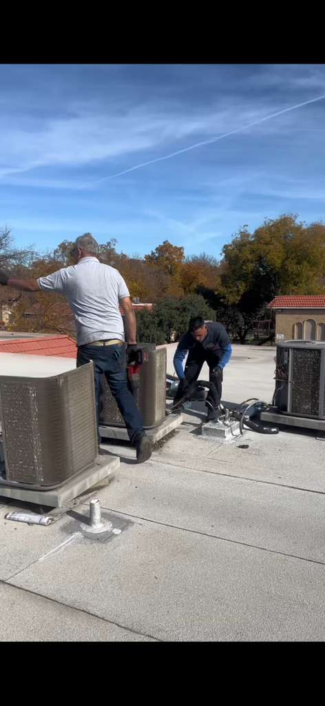 Heshma Air Conditioning technicians performing a coordinated HVAC installation